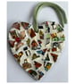 A lovely heart shaped mosaic pendant a brown, blue, green theme.