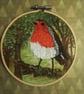 Embroidered robin in woodland . - Image 1