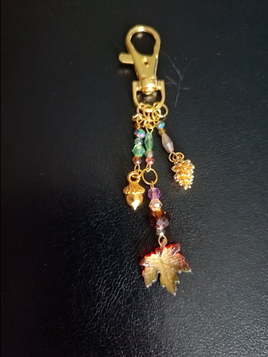 Gold autumnal beaded bag charm with leaf, acorn and pine cone charms 