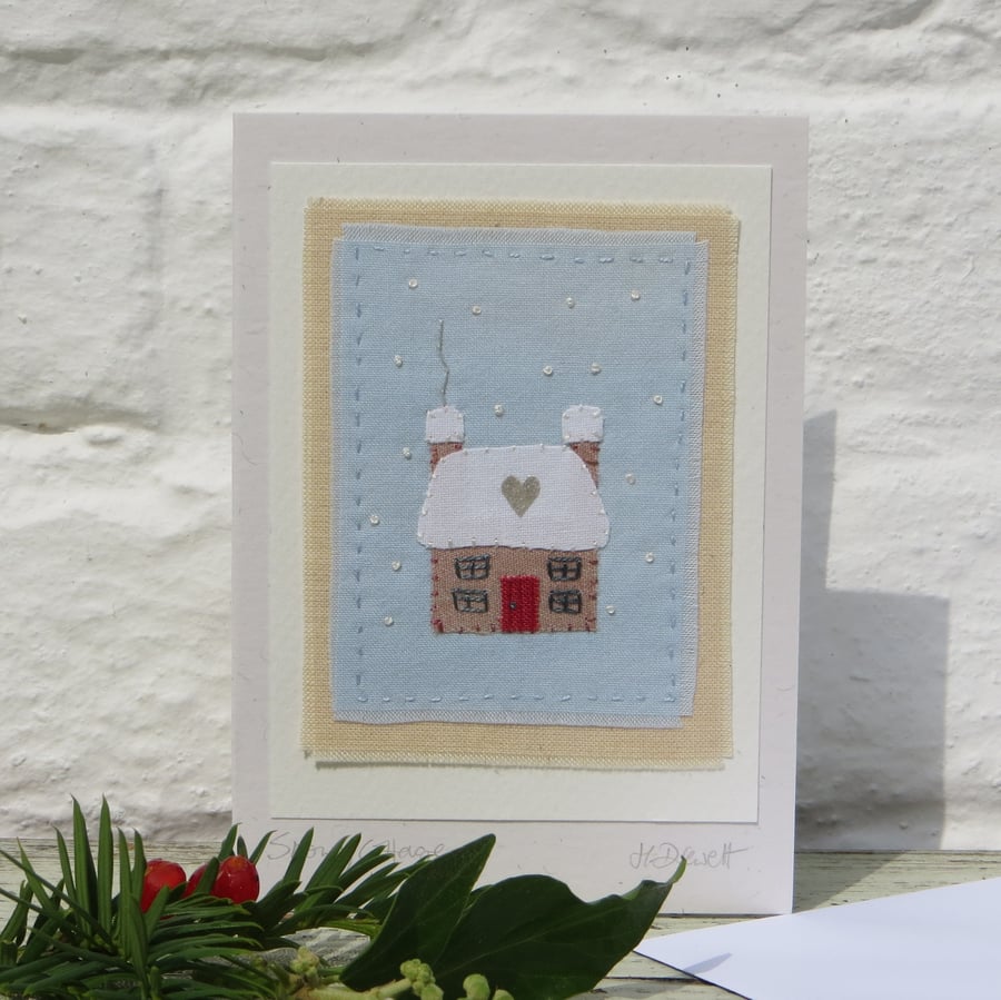 Snowy Cottage hand-stitched miniature textile with tiny silver heart on the roof