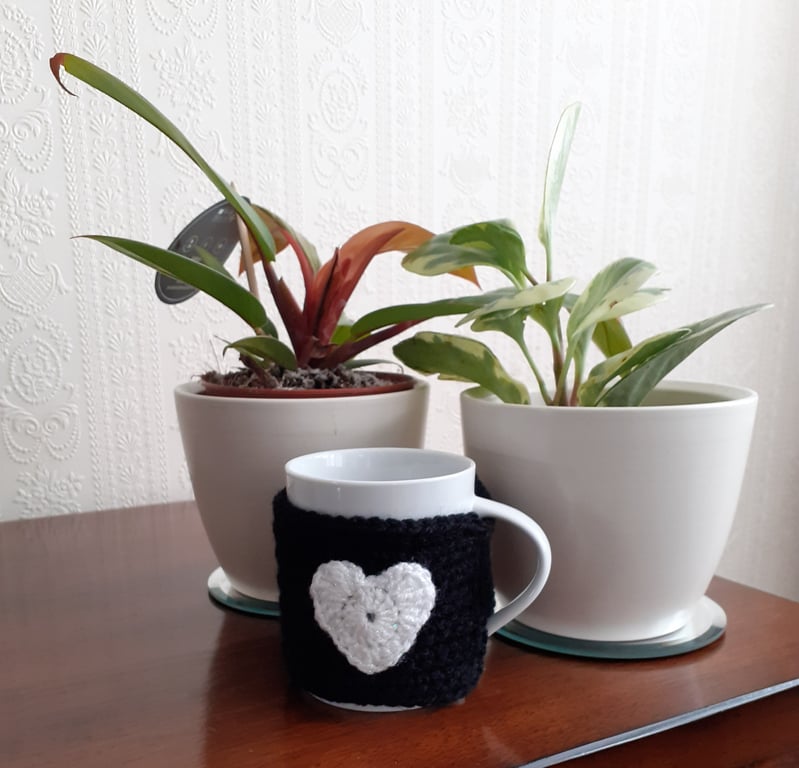 BLACK CROCHET MUG COZY WITH A GLITTERY HEART  ON  EITHER SIDE
