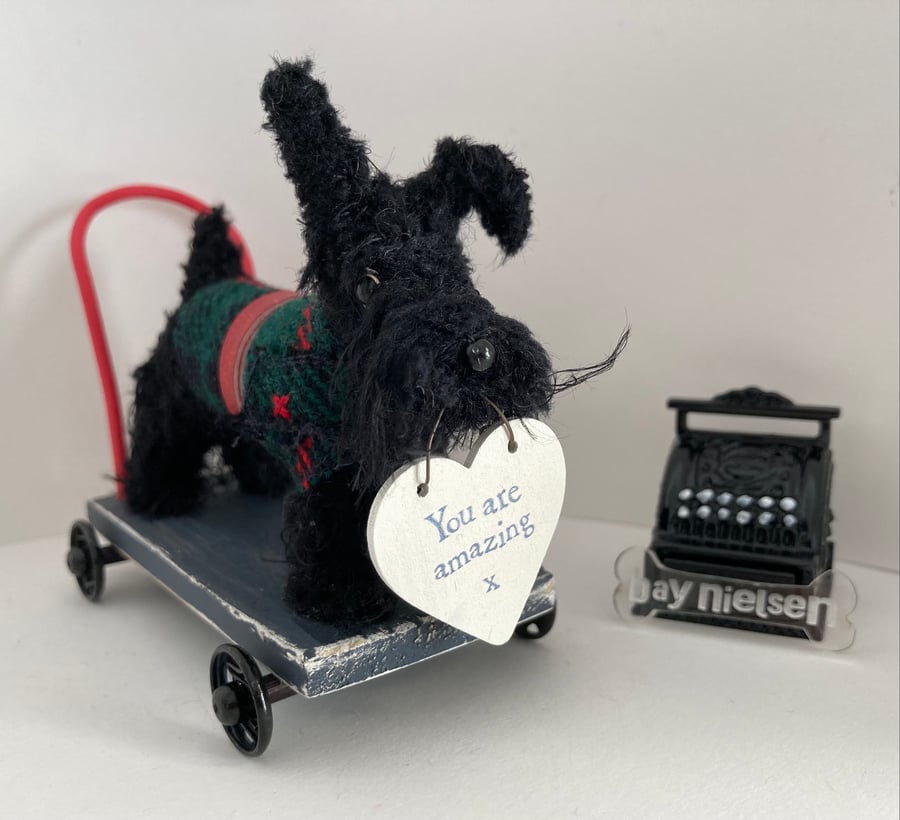 Miniature Scottie on a Push Along Trolley. 