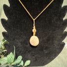 Beautiful wire wrapped pebble pendant on gold coloured chain. 