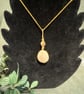 Beautiful wire wrapped pebble pendant on gold coloured chain. 