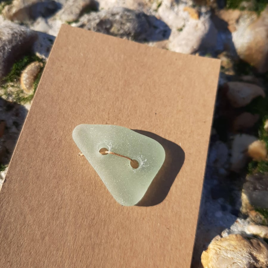 Large triangular very pale green sea glass button