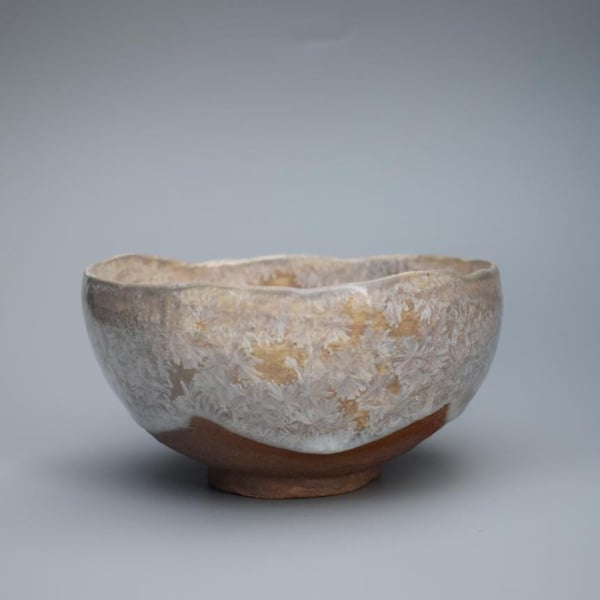 Stoneware ceramic bowl, a hand made pinch pot with a whitesilver crystalline gla