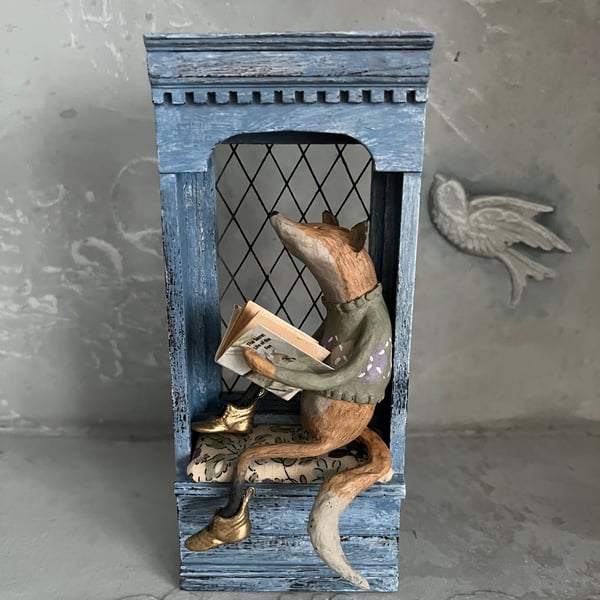 1:12 scale dolls house window seat featuring a small fox with golden boots