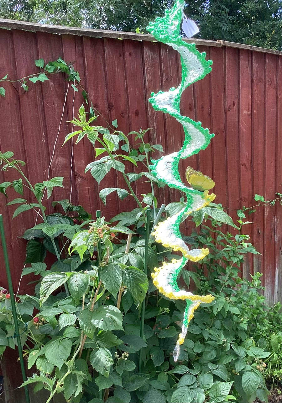Crochet wind spinner garden decoration in yellow white and green