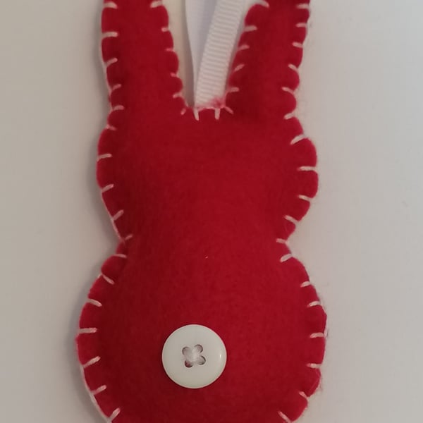 Handmade red felt rabbit with white stitching, ribbon and button 