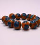Handmade teal and mustard daisy patterned lamp work glass beads - Image 5