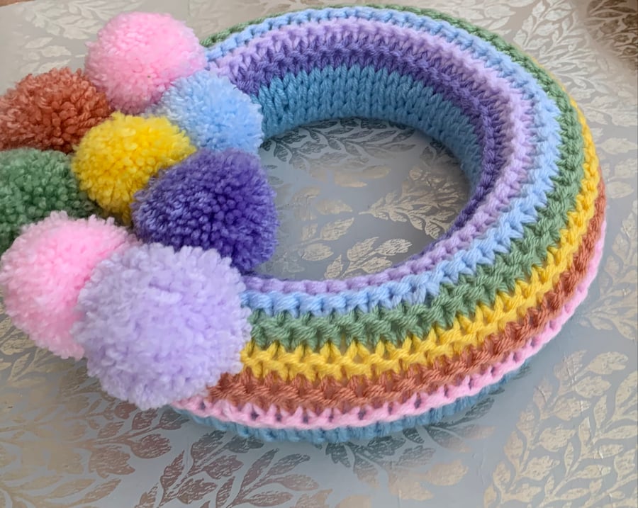 Knitted  spring pastel rainbow wreath with pom poms 