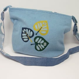 Fabric shoulder bag in soft blue with leaf applique details