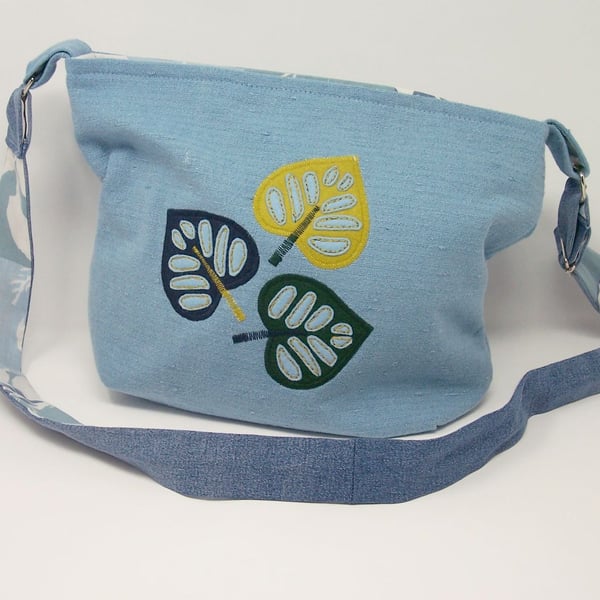 Fabric shoulder bag in soft blue with leaf applique details