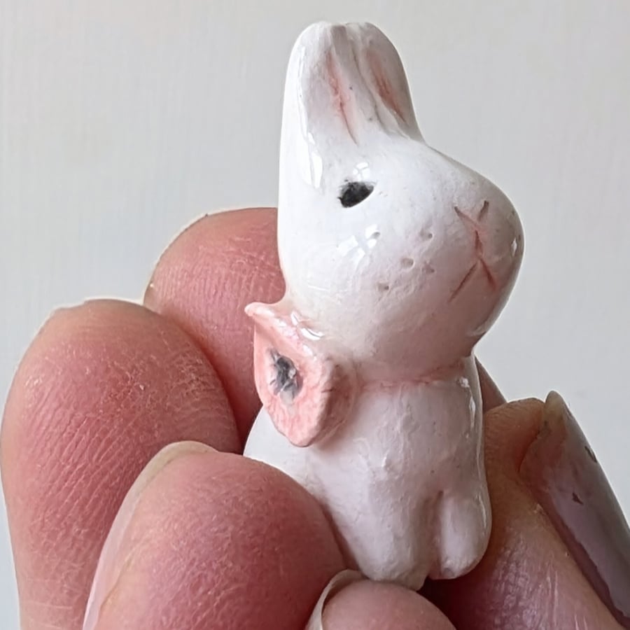 White bunny rabbit with pink poppy flower ceramic figurine 