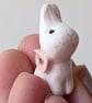 White bunny rabbit with pink poppy flower ceramic figurine 