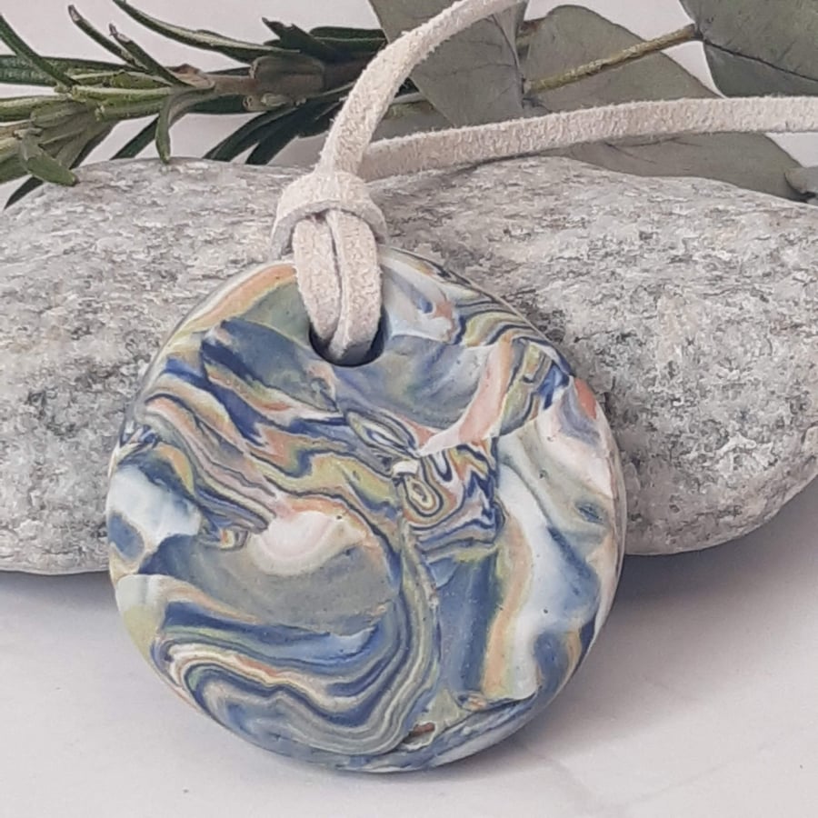 Handmade polymer clay round pendant in navy, pastel shades