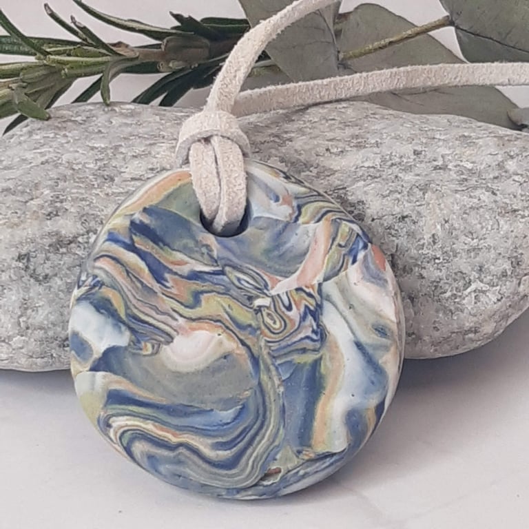 Handmade polymer clay round pendant in navy, pastel shades