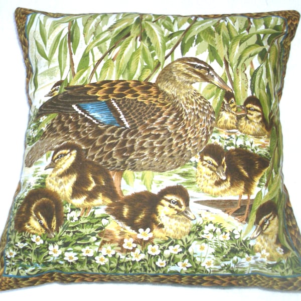 Mallard duck with her eight fluffy golden ducklings by the river bank cushion