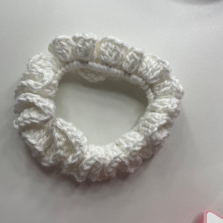 A cute white crochet scrunchie- an accessory for your hair.