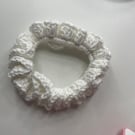 A cute white crochet scrunchie- an accessory for your hair.
