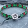 Dark green leather and red and green tile bead bracelet with decorative button 