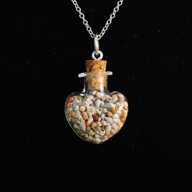 Glass heart pendant full of tiny shells 