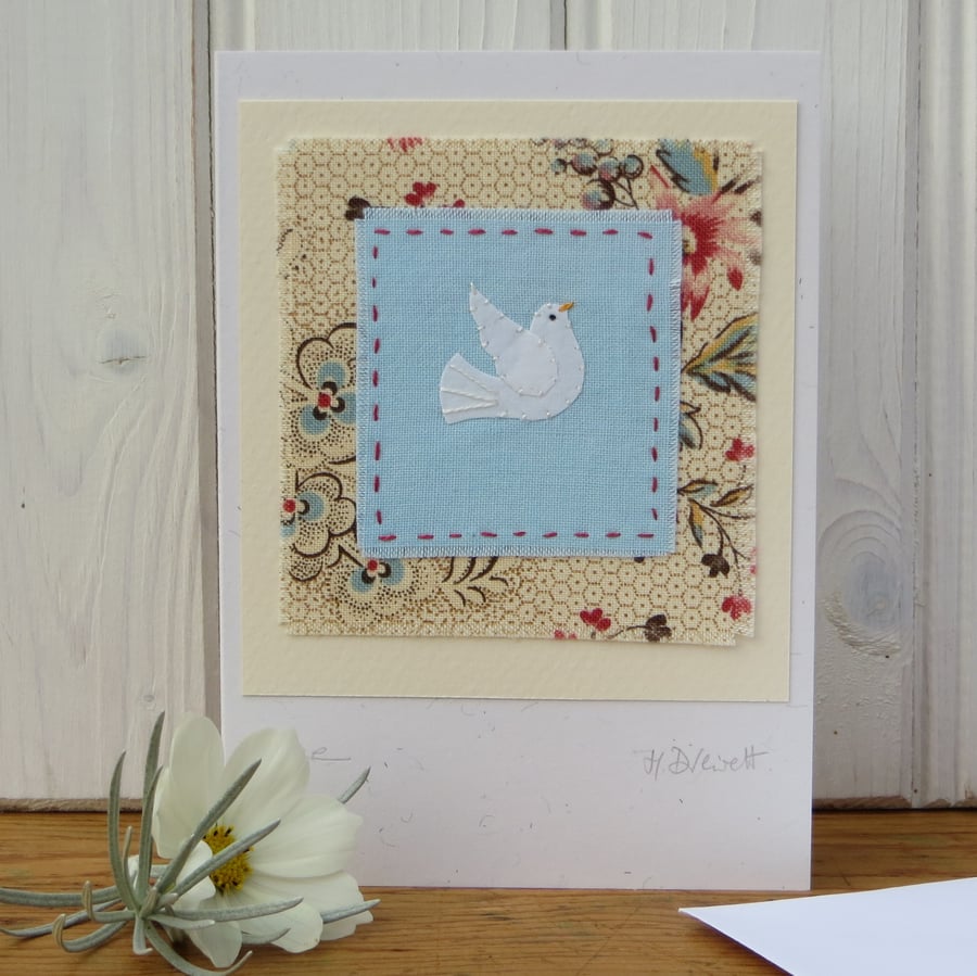 Dove of Peace hand stitched miniature with pretty fabric background