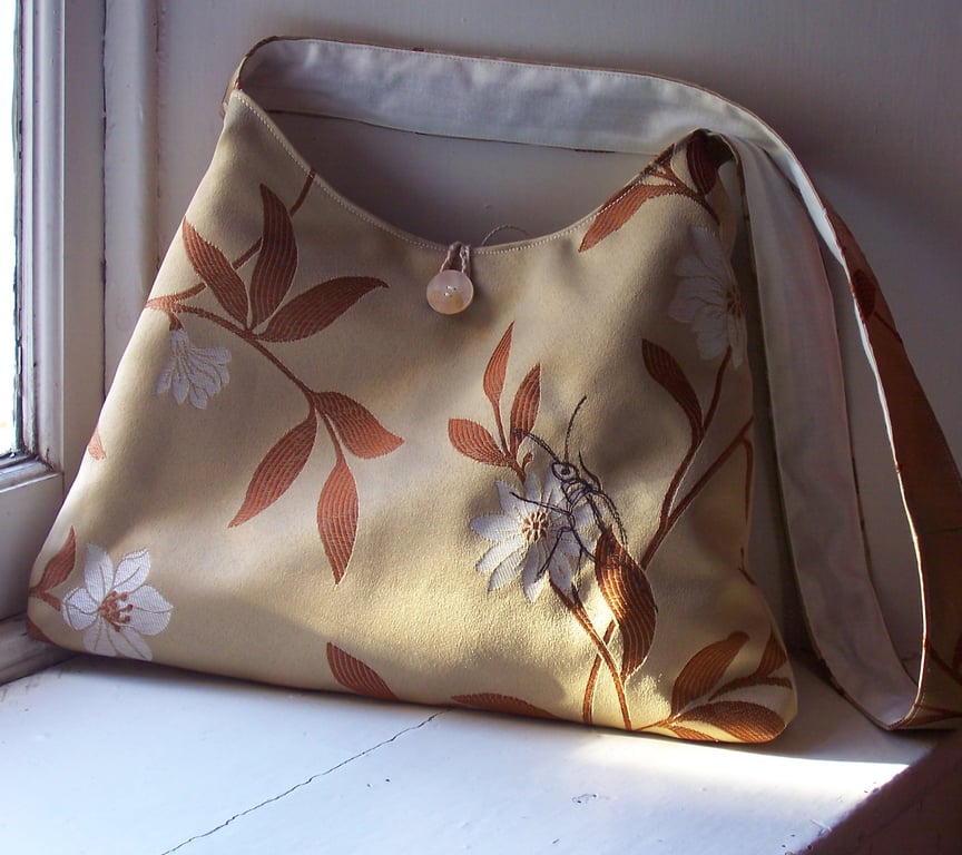 Soft fabric shoulder bag with machine embroidered beetle