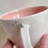 Handmade blue tit mug with pink glaze and musical notes 