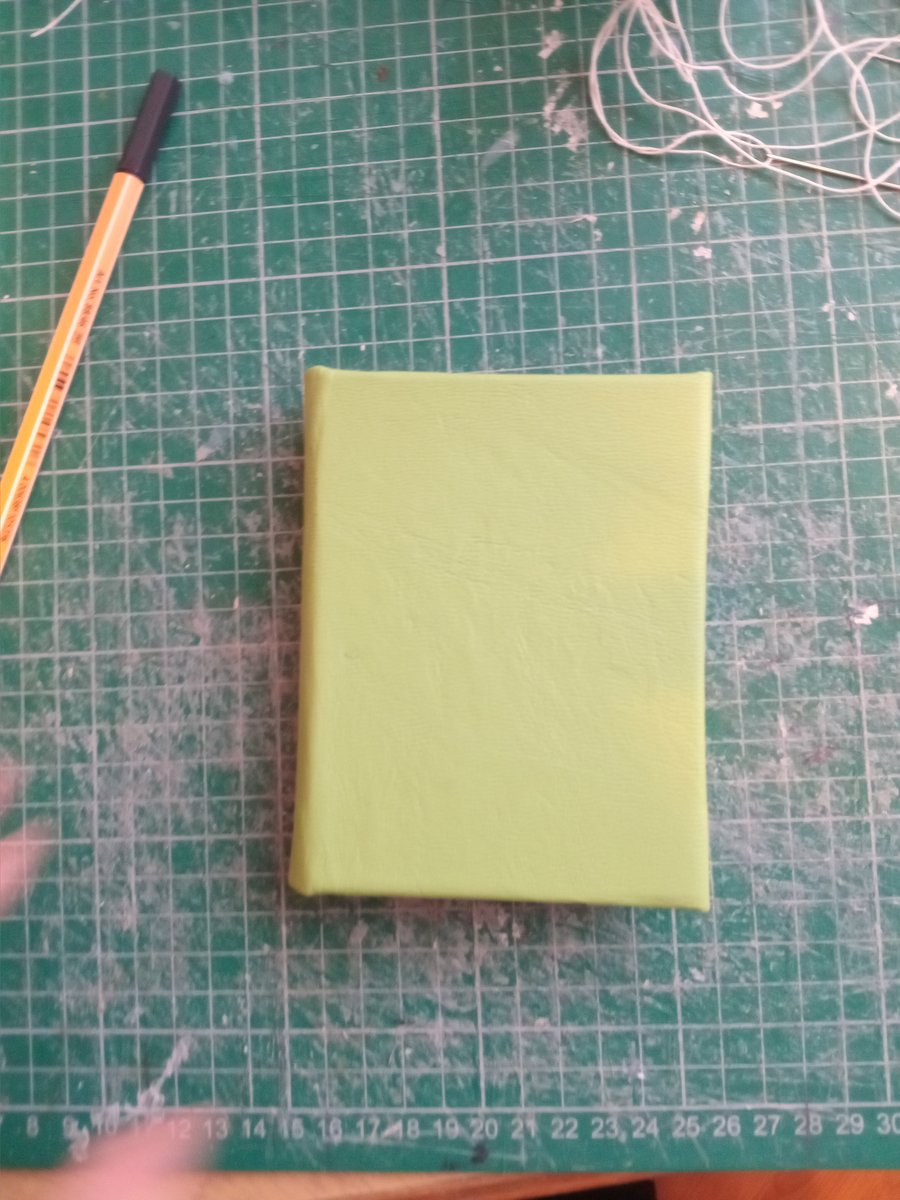 Small notebook with green leather binding, imperfectly handmade about  A7