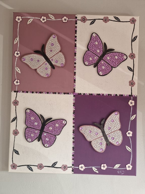 A quartet of sequinned butterflies on canvas. 