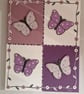A quartet of sequinned butterflies on canvas. 