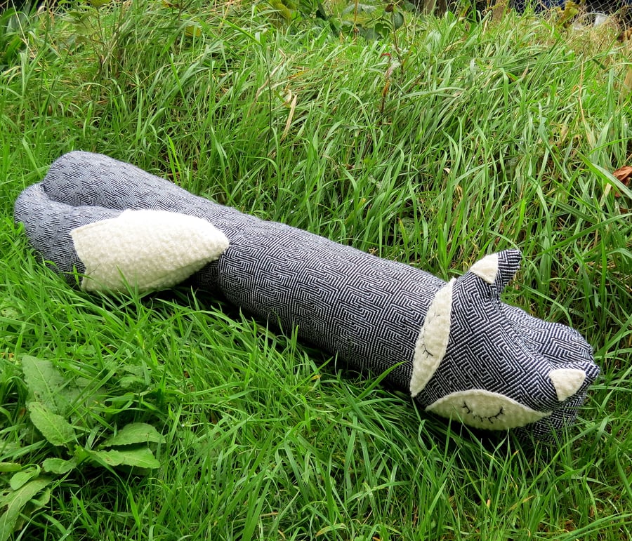 A snoozy fox draught excluder.  Door decor.