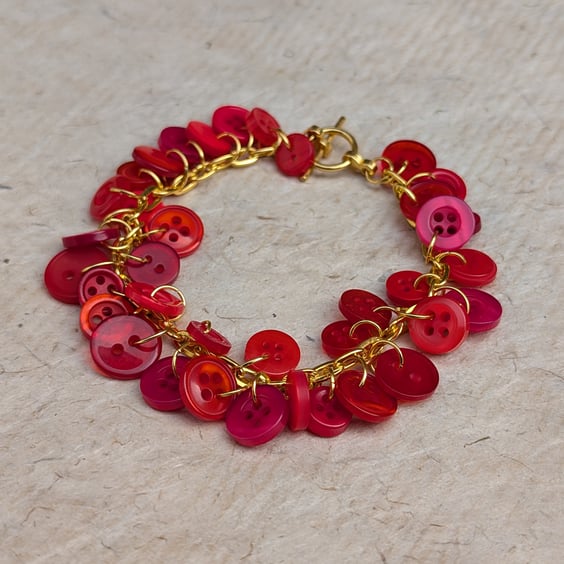 Red button bracelet with gold chain and toggle clasp 