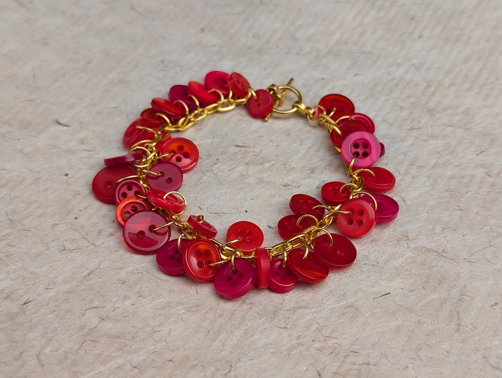 Red button bracelet with gold chain and toggle clasp 