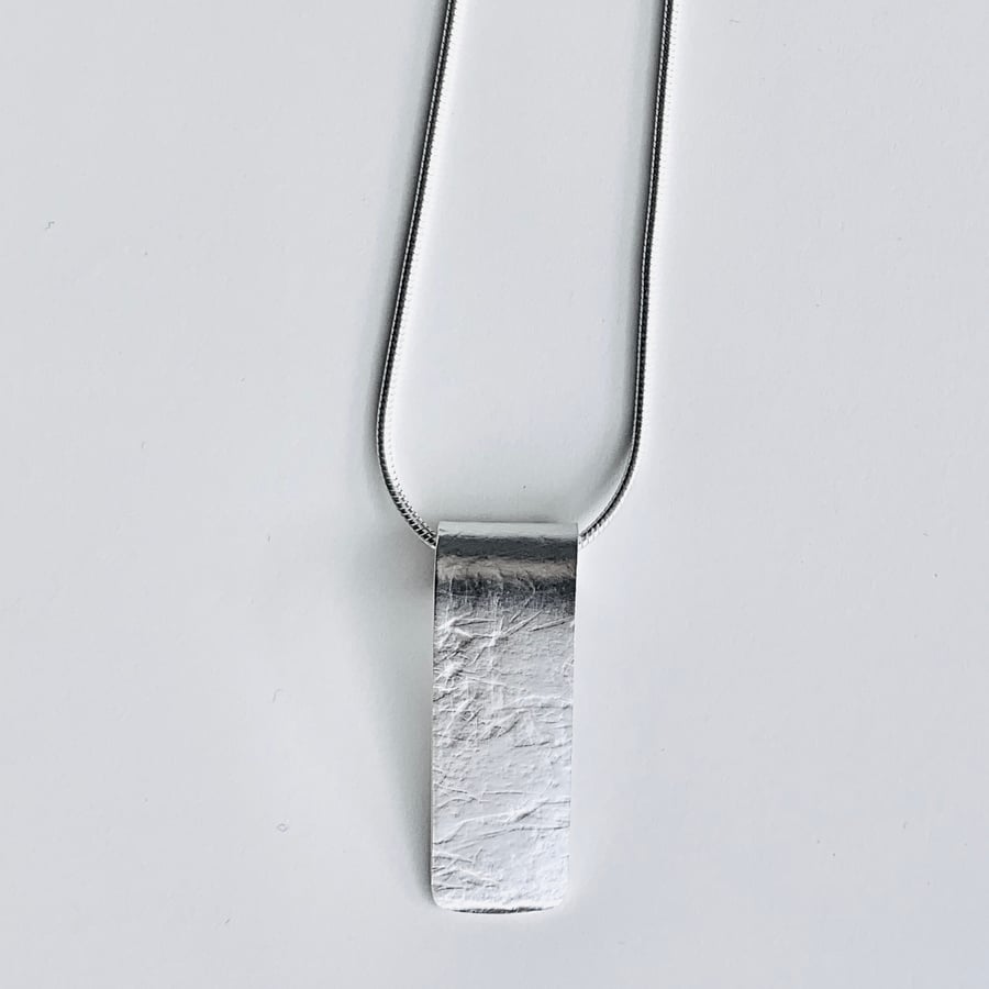 Textured silver tag pendant