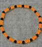 UV Reactive Orange Glass Bead and Black Glass Bicone Elastic Bracelet - Image 3