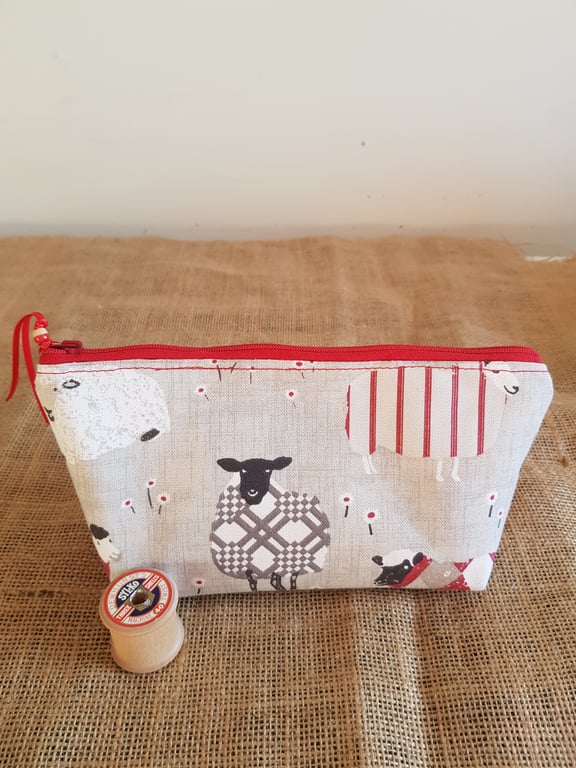 Zipped pouch: sheep with red.