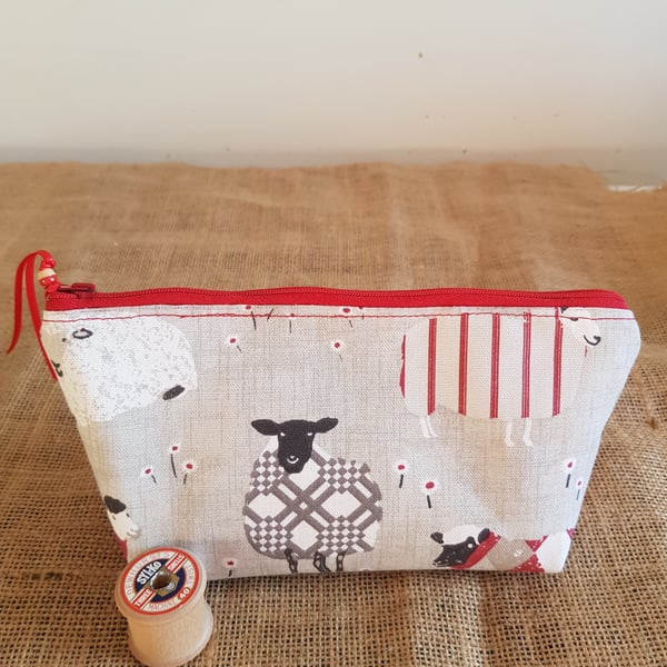 Zipped pouch: sheep with red.