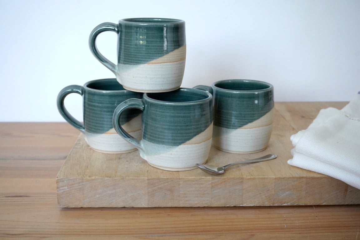 One cozy stoneware pottery tea mug glazed in ice blue and vanilla cream