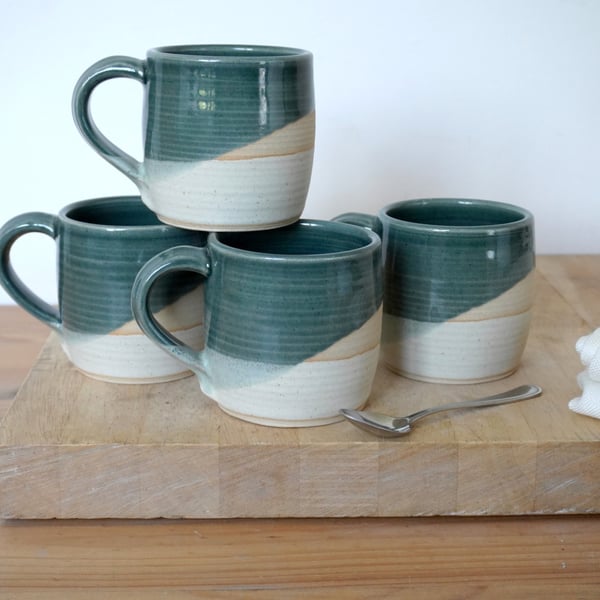 One cozy stoneware pottery tea mug glazed in ice blue and vanilla cream