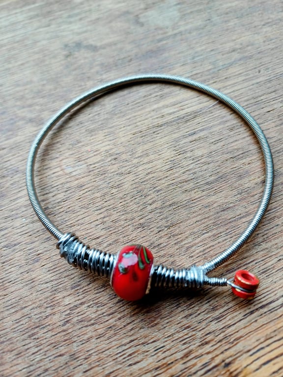 Up-Cycled guitar string bangle.  Funky !