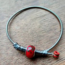 Up-Cycled guitar string bangle.  Funky !