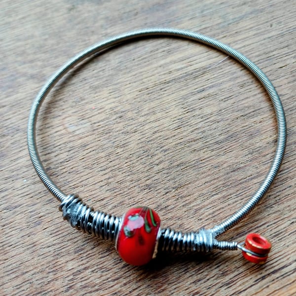 Up-Cycled guitar string bangle.  Funky !