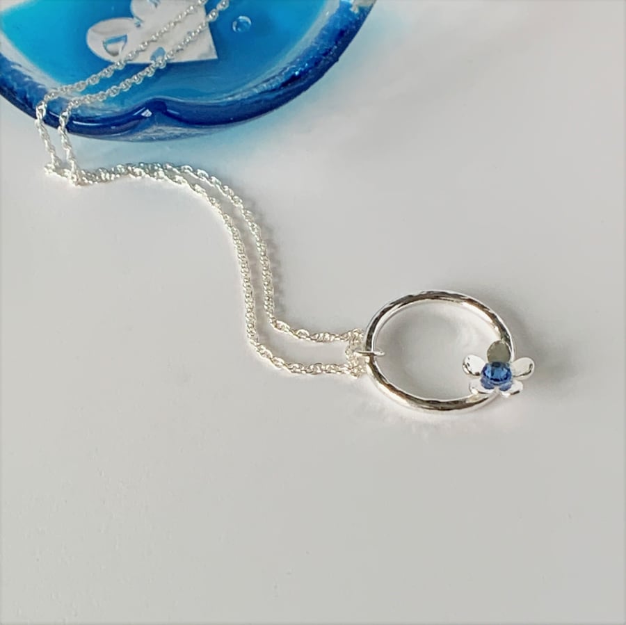 Eco Sterling Silver Hammered Circle Pendant with Blue Crystal set Daisy