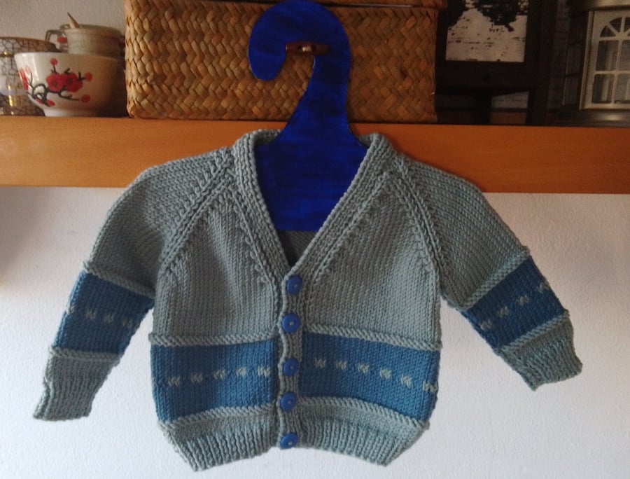 Handmade baby cardigan and hat set.