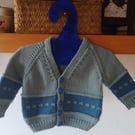 Handmade baby cardigan and hat set.