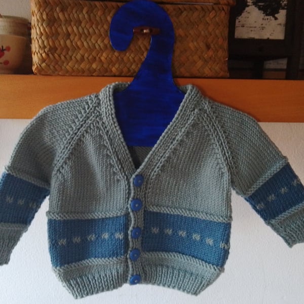 Handmade baby cardigan and hat set.