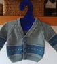 Handmade baby cardigan and hat set.