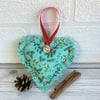 Mint green Christmas hanging heart decoration with holly and mistletoe